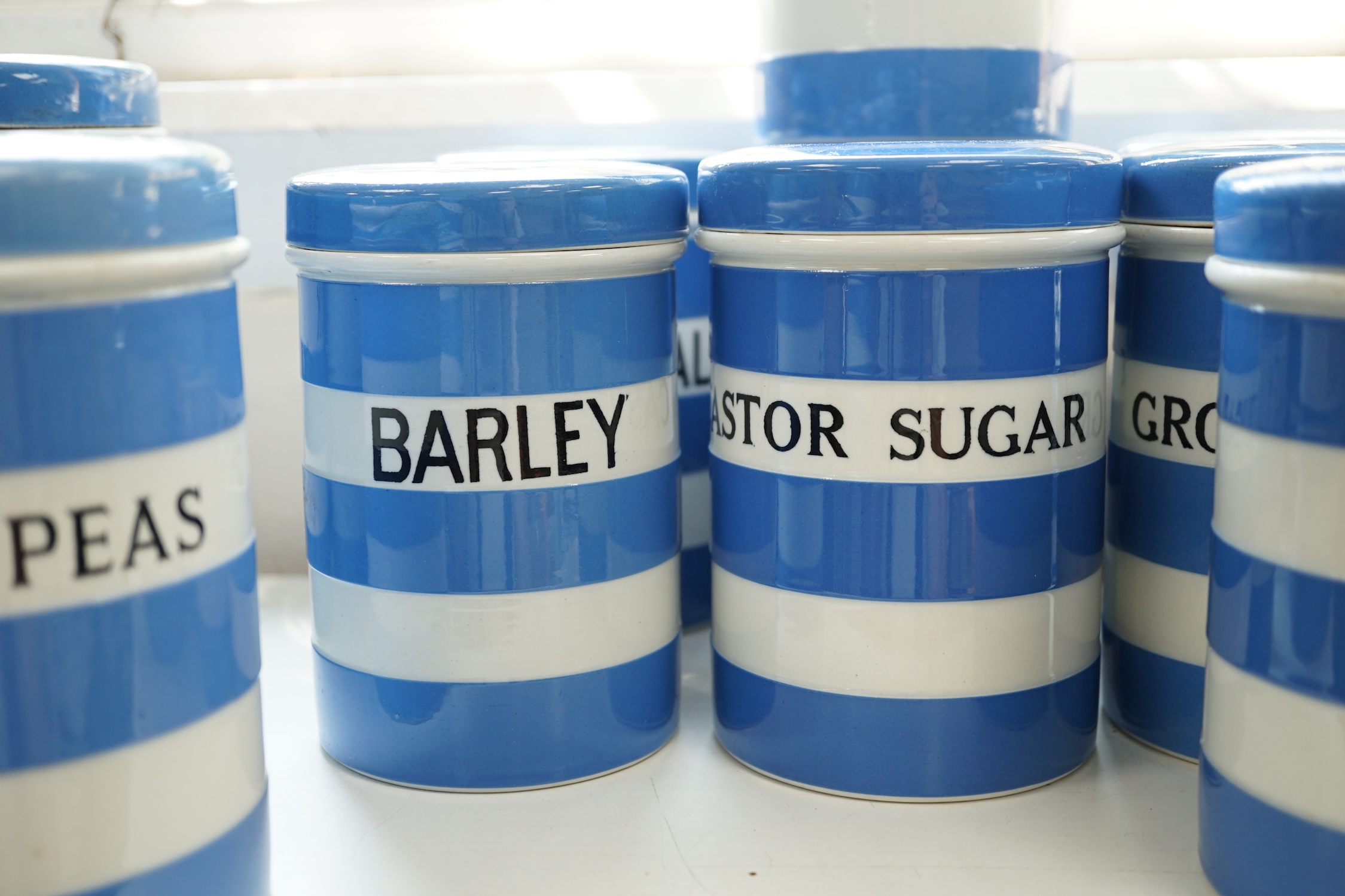 T.G.Green Cornish Kitchenware, ten 14cm lidded storage jars to include Green-Peas, Split- Peas, Cornflour, Ground Rice and Barley, mainly Black Shield marks. Condition - poor, fair and good